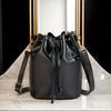 Elegant Black Drawstring Bag with Golden Hardware Accents Adjustable Shoulder Strap, Perfect for Daily Use, Handbag