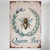 Vintage Rustic Bee Wreath Metal Tin Sign with Blue Floral Frame, 'Queem Boe' Cursive Text - Antique Aged Beige Background for Ho
