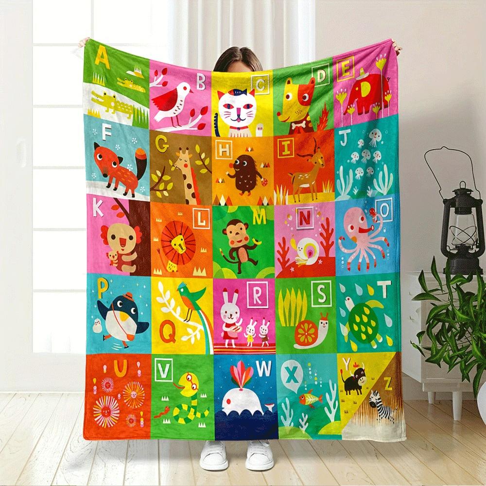 The pattern features alphabet letters paired with illustrated animals. for all seasons blanket lunch break throw gift