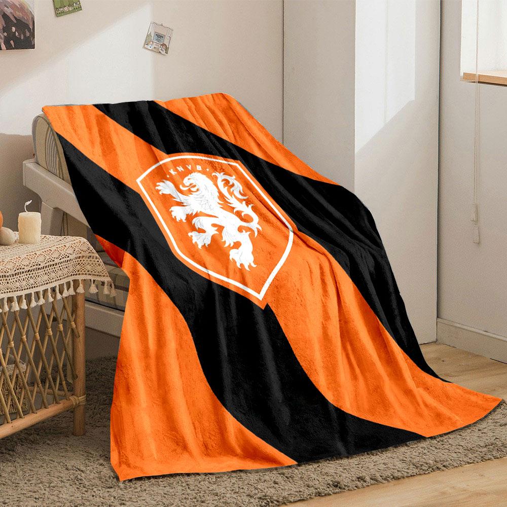 Diagonal black stripes on an orange background with a lion crest. for all seasons blanket lunch break throw gift