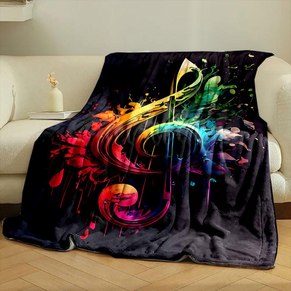 A vibrant treble clef blends with splashes of multicolored paint on black. for all seasons blanket lunch break throw gift