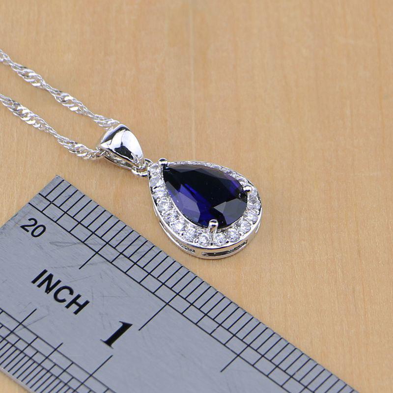 Набор ювелирных украшений под серебро с камнями синего цвета каплевидной формы по центру и мини стразами вокруг