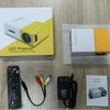 Best-Selling YG300 Yellow-White Mini Portable Projector with Mobile Screen Mirroring for Home Entertainment.