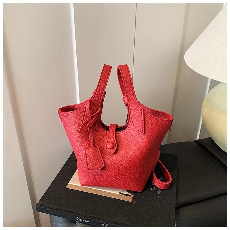 Оптовая продажа 2025 новая нишевая сумка-тоут с узором личи, женская корейская версия, простая сумка-ведро, повседневная сумка-мессенджер