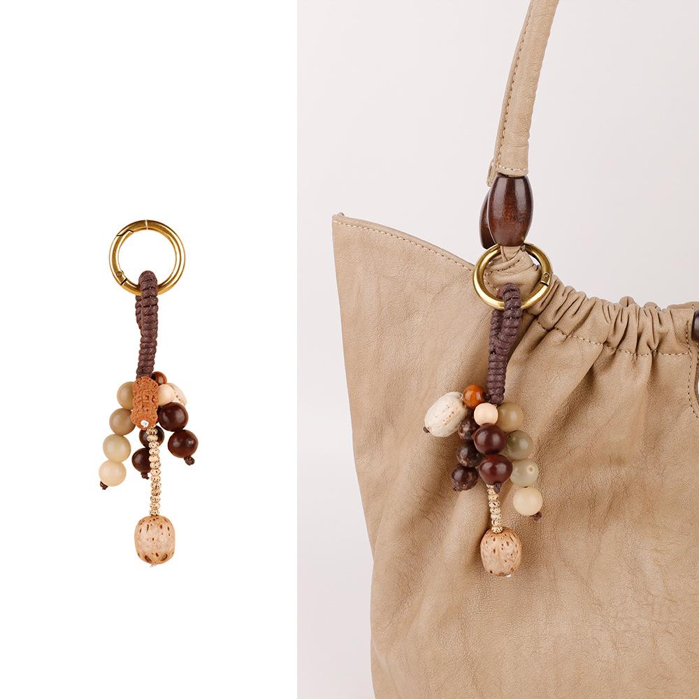 Wish-Fulfilling Bodhi Seed String Bag Charm - Hand-Woven Natural Keychain Ornament with Turquoise.