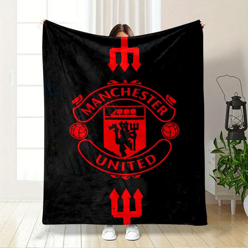 A red Manchester United emblem with tridents on a black background. for all seasons blanket lunch break throw gift
