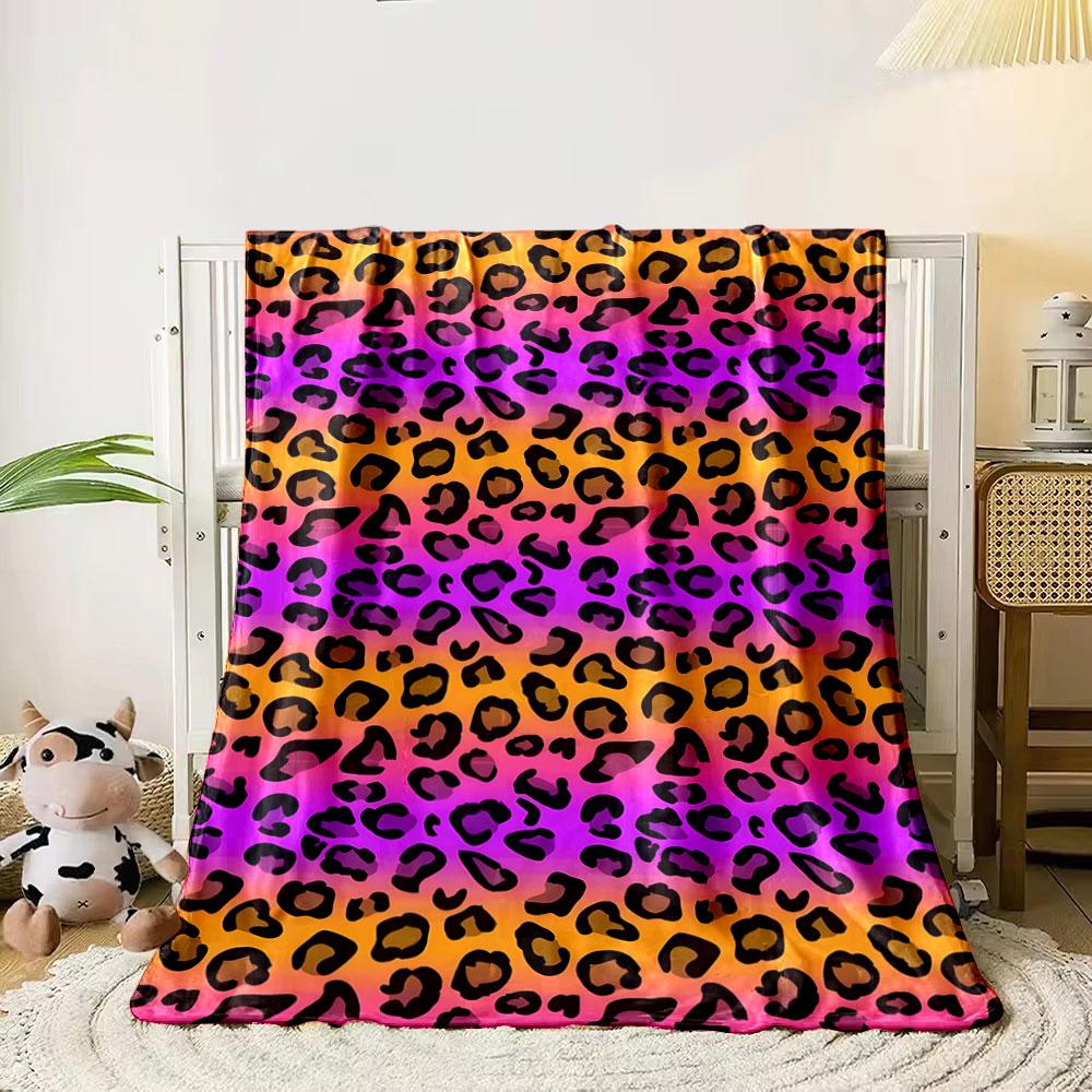 Black leopard spots on a gradient background of orange, pink, and purple. for all seasons blanket lunch break throw gift
