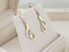English 585 gold dangling earrings, elegant design with white zircons