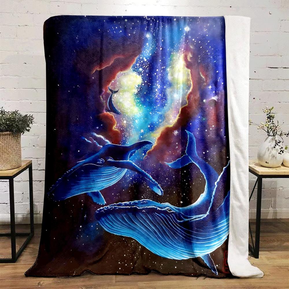 Glowing blue whales drift in a cosmic scene with vibrant nebulae and stars. for all seasons blanket lunch break throw gift