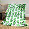 The pattern features rows of small green cartoon dinosaurs with red cheeks. for all seasons blanket lunch break throw gift