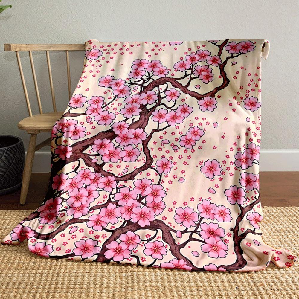 Pink cherry blossoms with brown branches and scattered petals on beige. for all seasons blanket lunch break throw gift