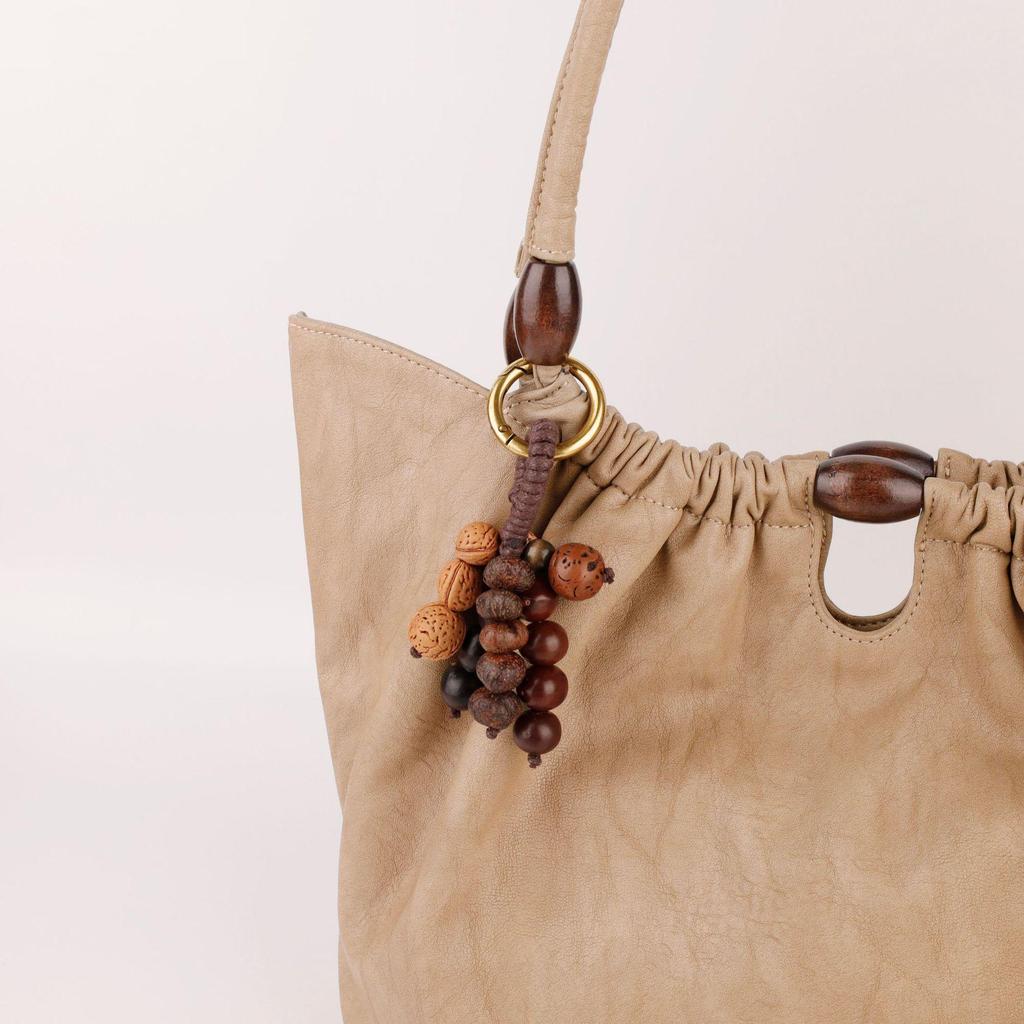 Wish-Fulfilling Bodhi Seed String Bag Charm - Hand-Woven Natural Keychain Ornament with Turquoise.