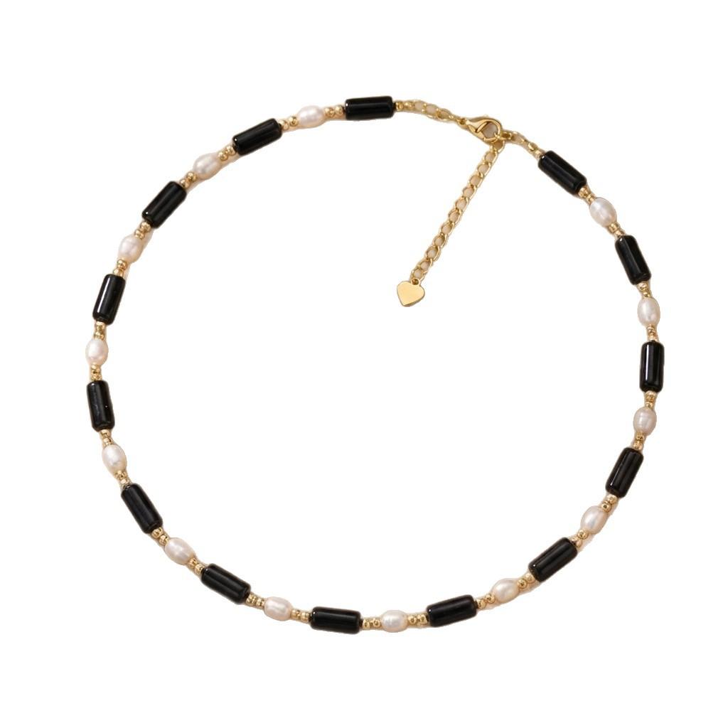 Rice-grain freshwater pearl and long black onyx necklace, a minimalist and chic clavicle chain for women, featuring a black and white color-block