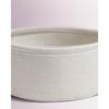 Small round loft coffee table with a pink 50cm cosmetic basket for flowers