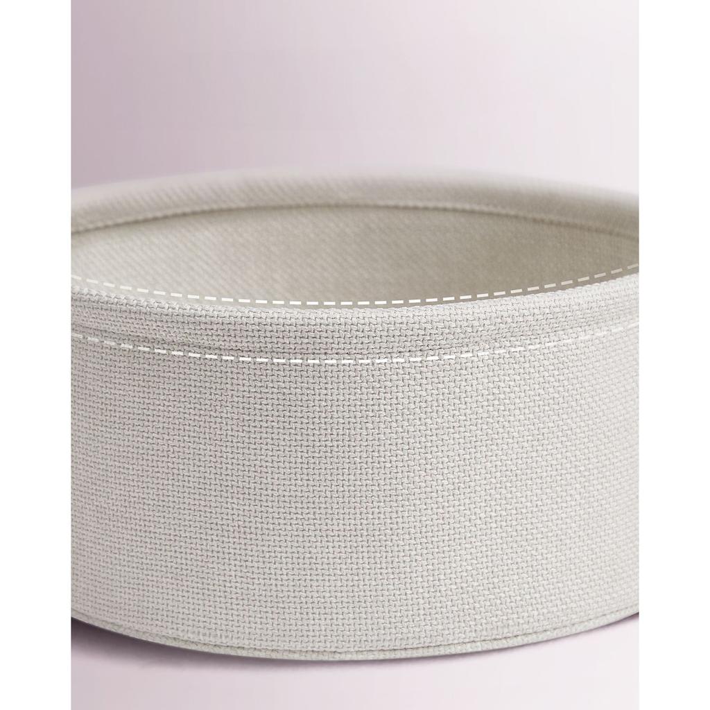 Small round loft coffee table with a pink 50cm cosmetic basket for flowers