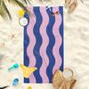 A Microfibre Beach Towel Featuring Trendy Blue And Pink Wavy Design,Perfect for Summer Enjoyment.It'S Both Stylish And Absorbent