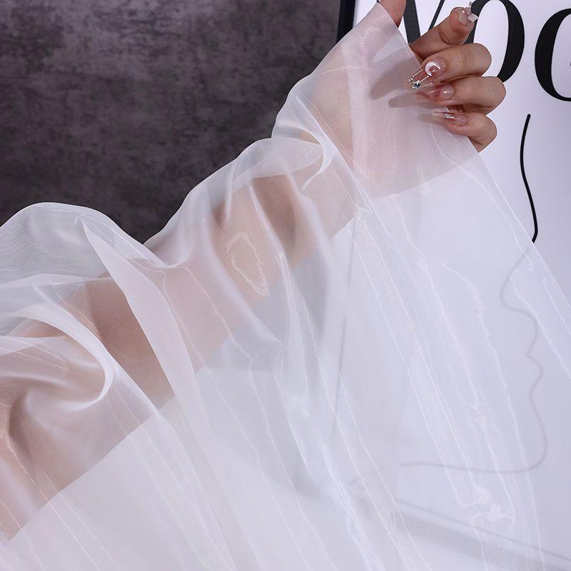 The thickened and encrypted soft light organza fabric can be used for wedding dresses evening gowns and designer clothing fabric