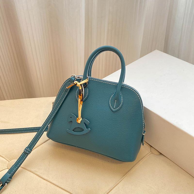 Премиальная мини-сумка-ракушка для женщин 2025 года, новая модная иностранная стильная изысканная сумка для переноски на одно плечо, диагональный пролет, воловья кожа, маленькая