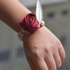 Цветы, украшающие запястье жемчужной цепочкой
