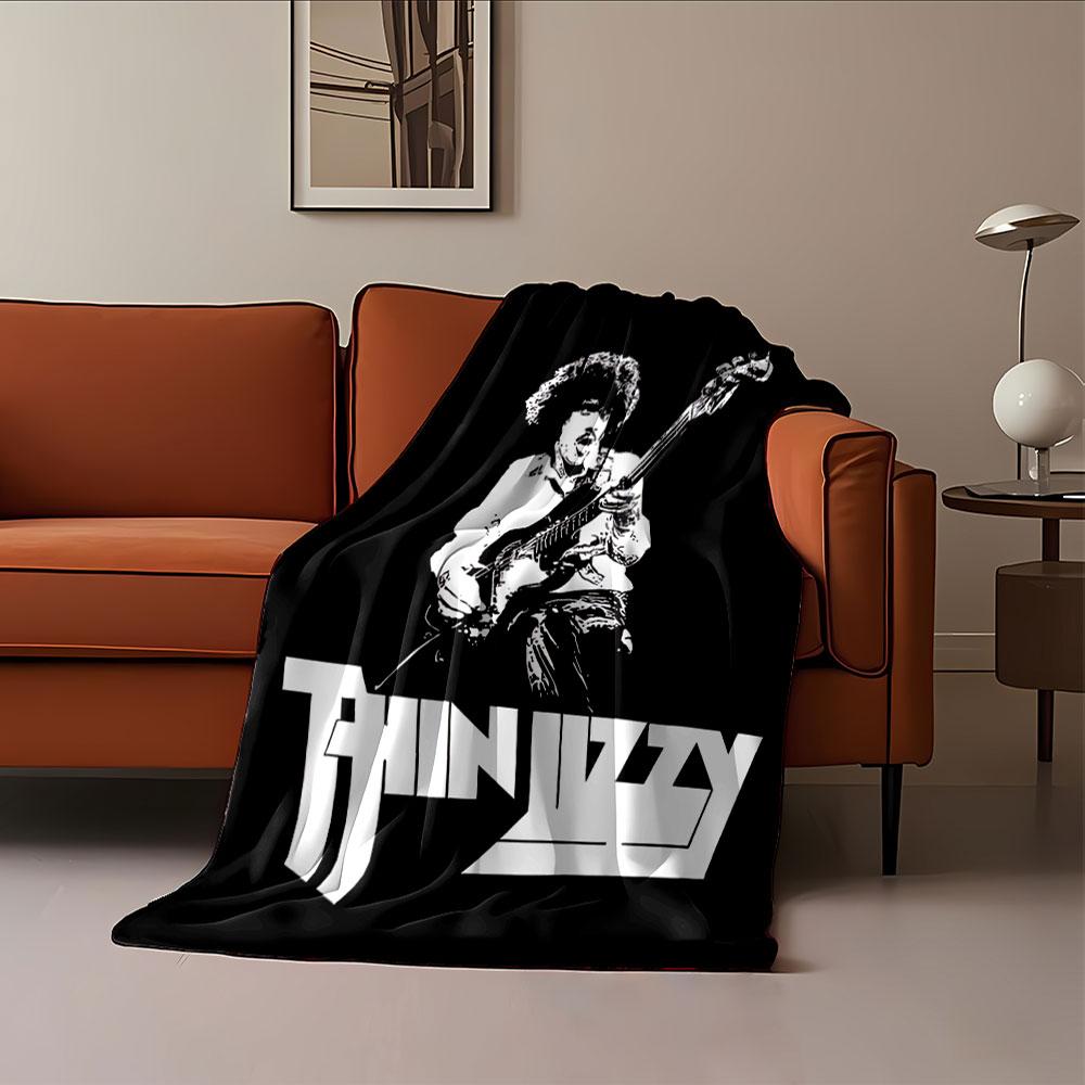 Stylized monochrome musician graphic with a bold "Thin Lizzy" logo. for all seasons blanket lunch break throw gift