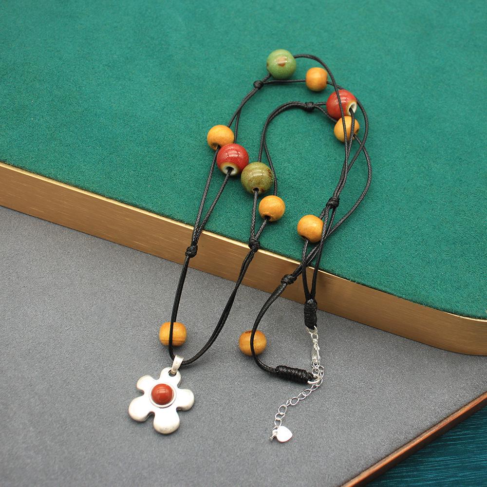 Керамическое ожерелье с фруктами и карибским цветком и серьги с красным камнем