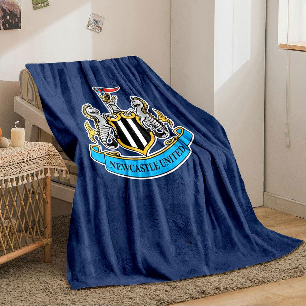 A shield with black and white stripes, flanked by seahorses, and a banner. for all seasons blanket lunch break throw gift