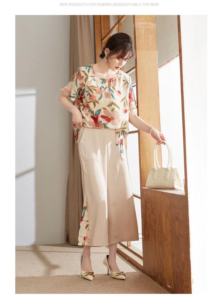 Летний стильный комплект из рубашки с цветочным принтом и широких брюк для женщин 2025 года