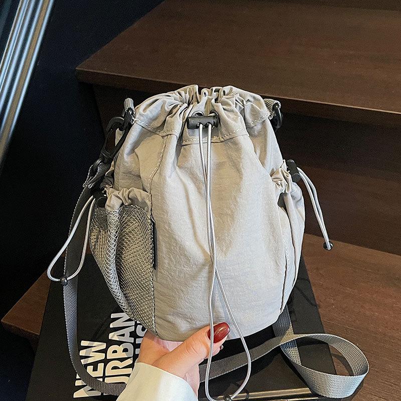 2025 New Japanese Leisure Niche Outdoor Sports Drawstring Bucket Bag Fashionable Versatile Light Travel Messenger Bag