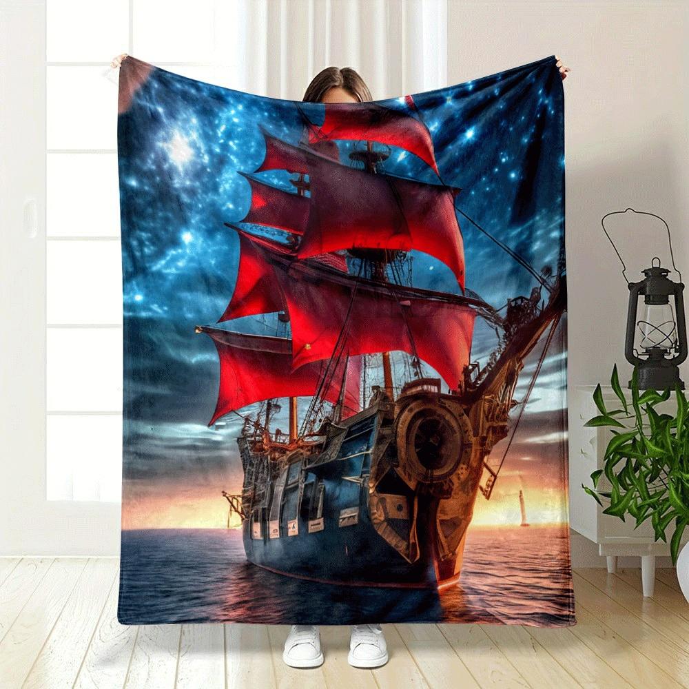 A ship with vibrant red sails against a starry night and sunset backdrop. for all seasons blanket lunch break throw gift