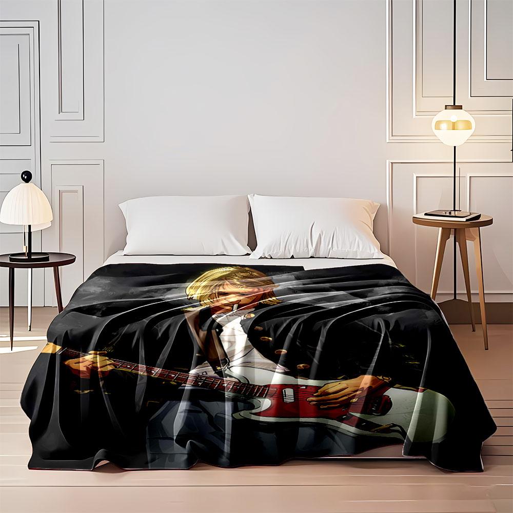 The main pattern shows a person playing a red-and-white electric guitar. for all seasons blanket lunch break throw gift