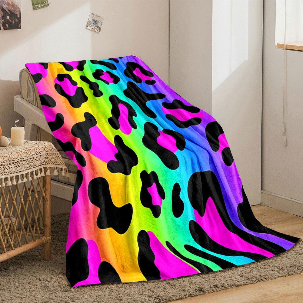 Leopard-like spots with black shapes on a vibrant rainbow gradient background. for all seasons blanket lunch break throw gift