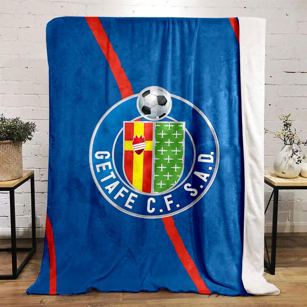 A blue background with red diagonal lines and a football club crest. for all seasons blanket lunch break throw gift
