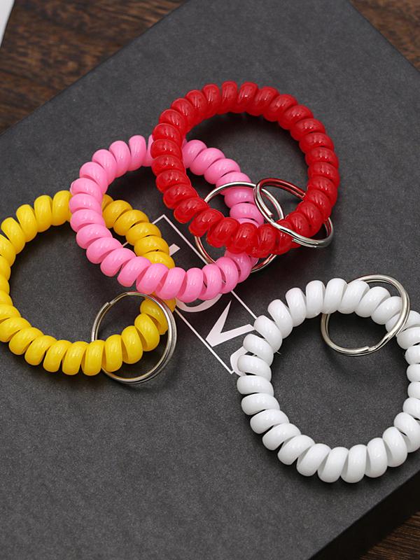 Минималистичный браслет-брелок и резинка для волос в виде пружинного механизма