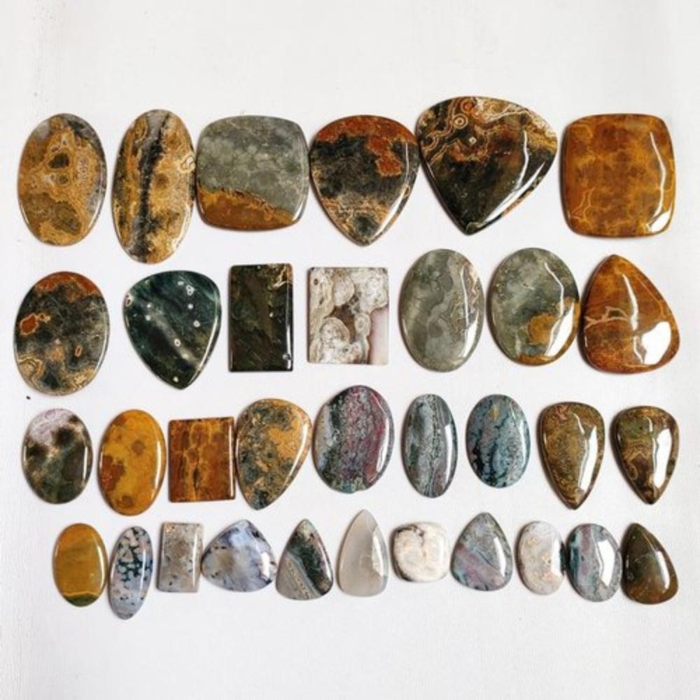 Натуральный кабошон из океанской яшмы. Партия кабошонов из океанской яшмы по весу, разных форм и размеров, используемых для изготовления ювелирных изделий.