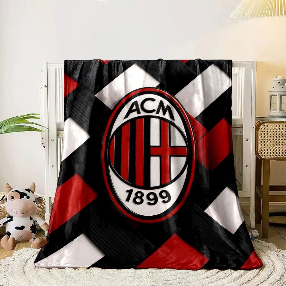 Interwoven red, black, and white strips with an oval emblem in the center. for all seasons blanket lunch break throw gift