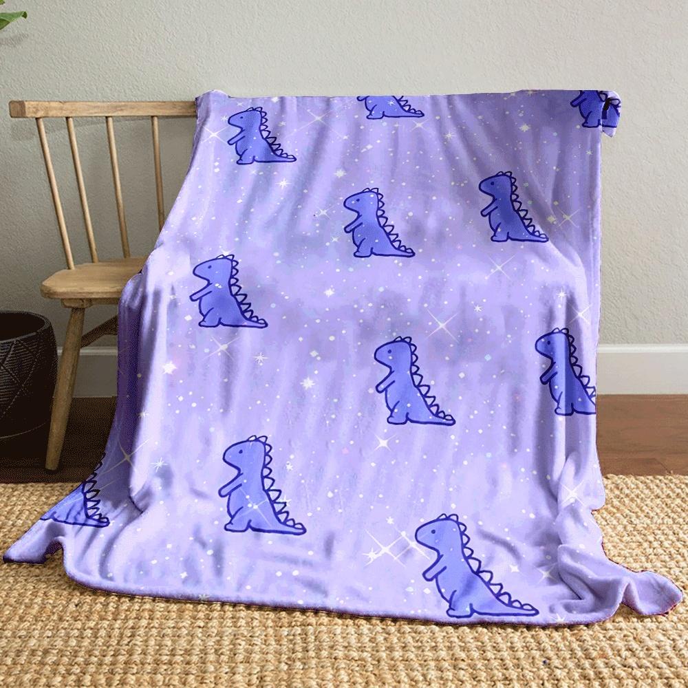 Cute purple dinosaurs scattered on a sparkly, pastel purple background. for all seasons blanket lunch break throw gift
