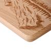 Wooden chopping board with engraved boat and mountains