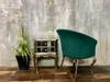 Green velvet living room armchair with silver legs in glamour style