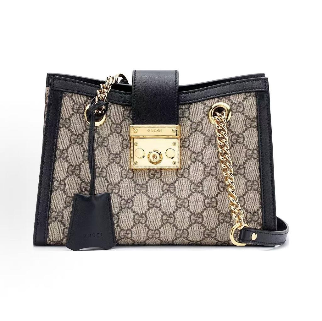 Gucci Сумка-тоут с замком-навесом, украшенная аксессуаром золотистого цвета, пряжкой-застежкой с ключом, старым цветочным логотипом и холщовой сумкой на плечо.