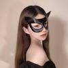 Cosmetic masquerade party with a sexy half-face makeup woman wearing a half-face erotic lace mask, a Halloween feather mask