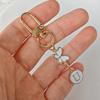 1Pc Key Logo Monogram Charm Key Fob Durability Bag Charm Lightweight Butterfly Monogram Keychain Car Key Companion Metal Keychain