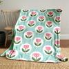 Pink tulips within white circles on a teal background. for all seasons blanket lunch break throw gift