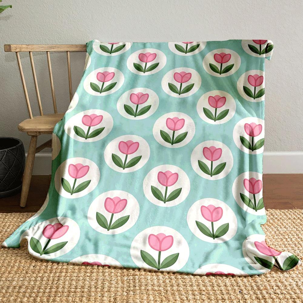 Pink tulips within white circles on a teal background. for all seasons blanket lunch break throw gift