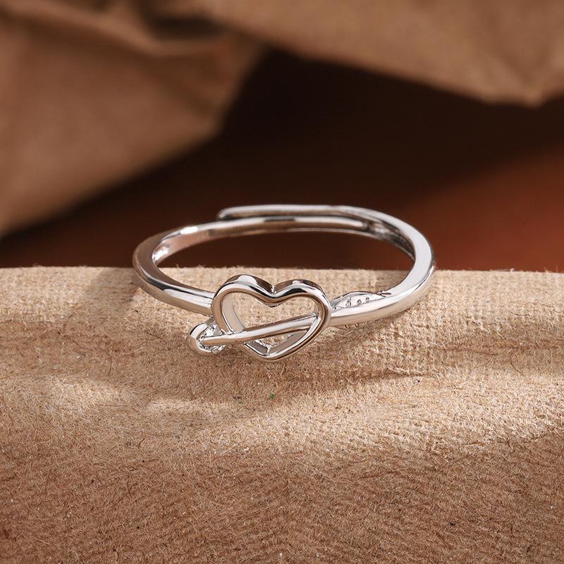 Exquisite New Year Style Hollow Heart Ring: Trendy Woman's Design with Arrow Through the Heart.