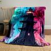 A black lighthouse stands amid vibrant pink and teal swirling clouds. for all seasons blanket lunch break throw gift