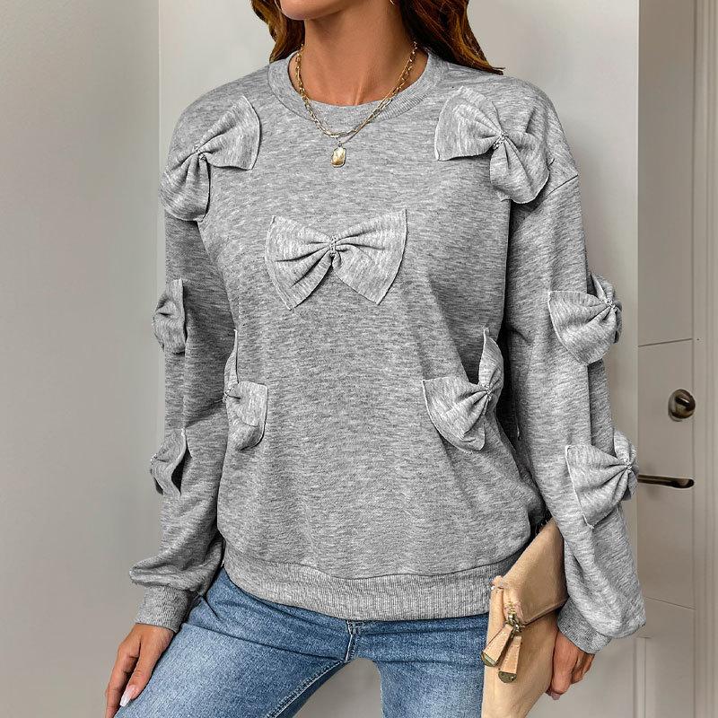 A Sweet and Casual Autumn Woman In A Grey Round-neck Hoodie with A Bow and A Unique Style