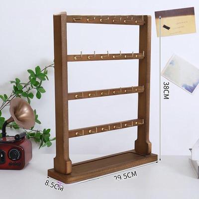 Деревянная подставка для украшений для серег, брелоков и браслетов с крючками и местом для хранения нитей с бусинами.