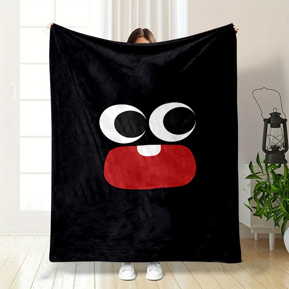 Large cartoon eyes and a red mouth with one tooth on a black background. for all seasons blanket lunch break throw gift