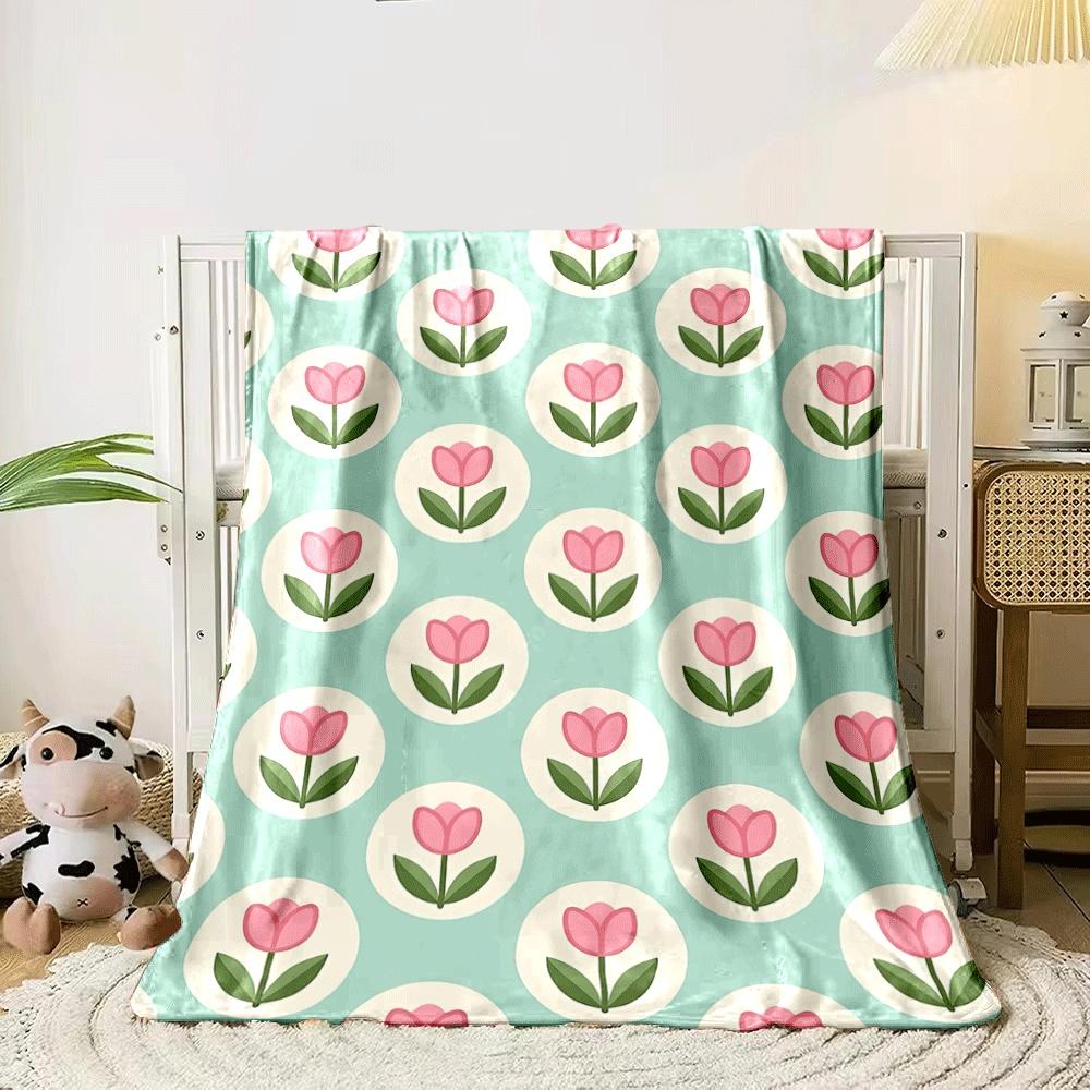 Pink tulips within white circles on a teal background. for all seasons blanket lunch break throw gift