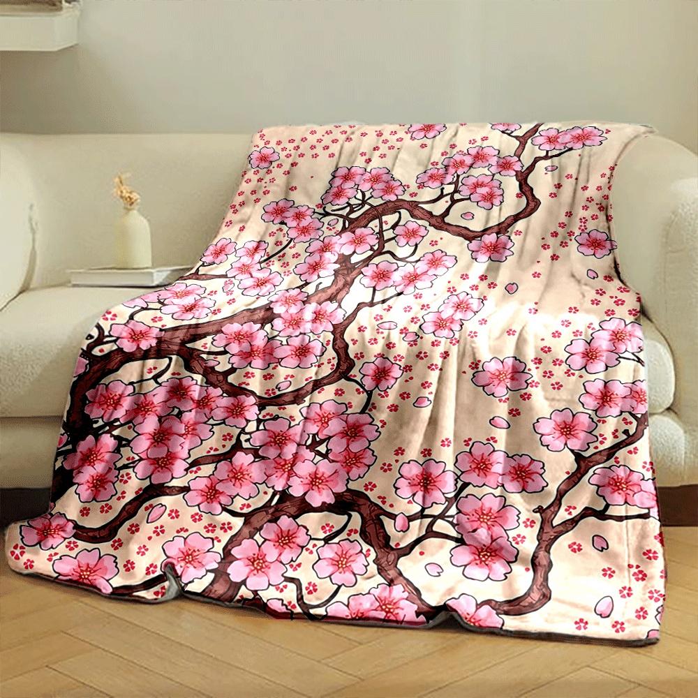 Pink cherry blossoms with brown branches and scattered petals on beige. for all seasons blanket lunch break throw gift